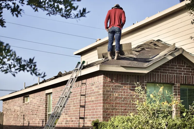 Professional roofer working on a residential roof in Carrolls